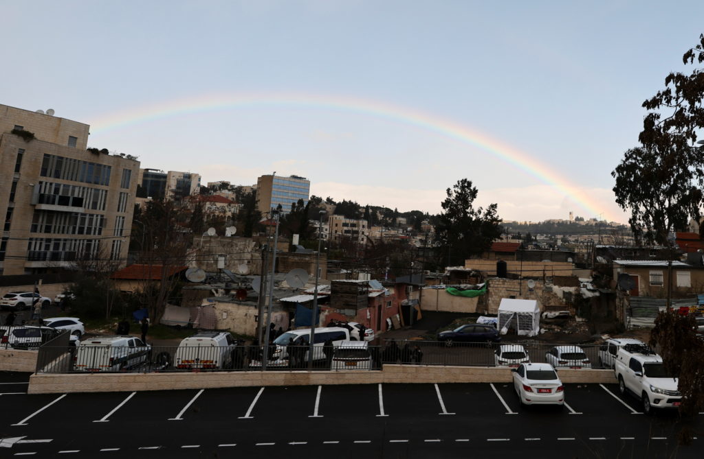 A rainbow is seen over Jerusalem's Sheikh Jarrah neighbourhood on a rainy day, February 25, 2022. Photo by Ammar Awad/Reuters