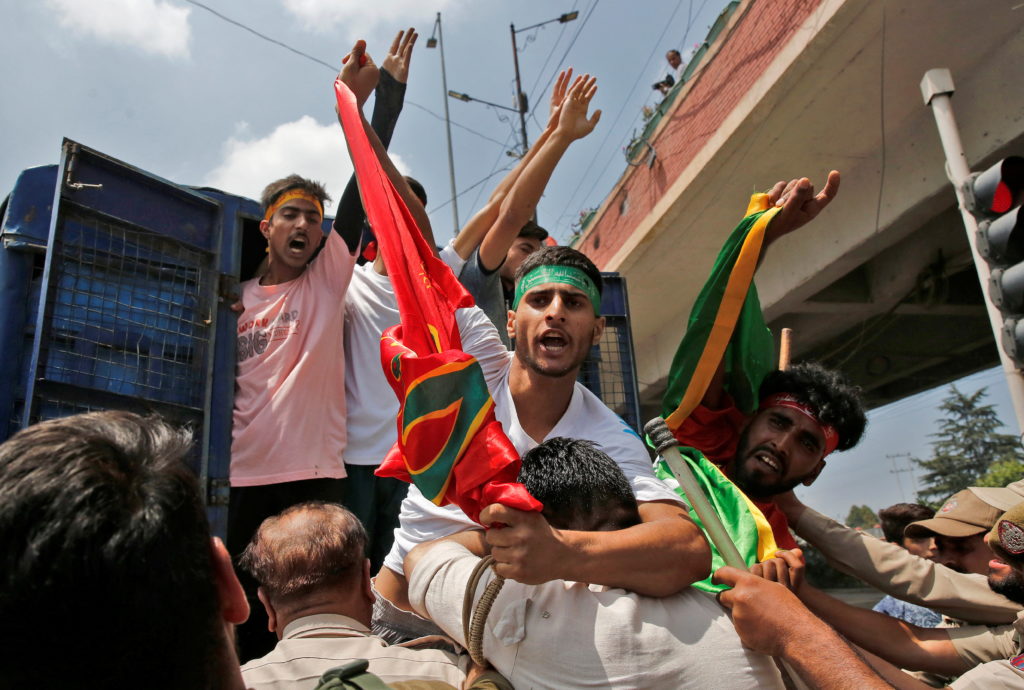 Kashmiri Shi'ite Muslim mourners shout slogans as they are detained by Indian police, in Srinagar