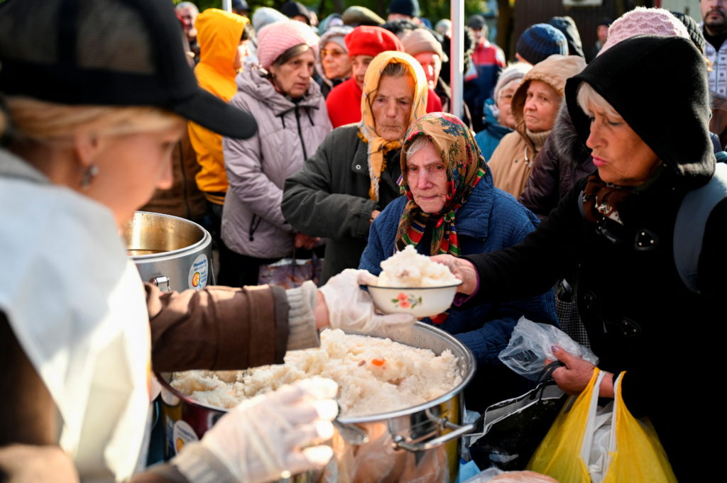 Local residents line up to receive a meal provided by the World Central Kitchen NGO, amid Russia's invasion of Ukraine, in...