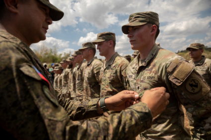 Philippine Army Artillery Regiment Commander Anthony Coronel attaches a patch to a U.S. soldier during the three-week joint military drills "Salaknib" at Fort Magsaysay, Nueva Ecija, Philippines, March 31, 2023. Photo by Eloisa Lopez/Reuters