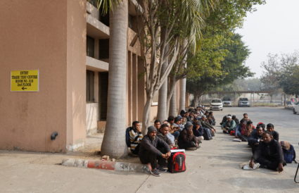 Skilled workers wait for their interview and skill test at a Haryana state government recruitment drive to send workers to...