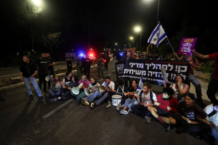 Protesters sit on the street, as they demand Israeli Prime Minister Benjamin Netanyahu's ouster, in the wake of the deadly October 7 attack on Israel by the Palestinian Islamist group Hamas and the ensuing war in Gaza, at a demonstration in Jerusalem, April 1, 2024. Photo by Ronen Zvulun/Reuters