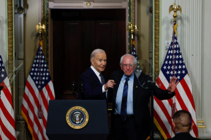 U.S. President Joe Biden and Senator Bernie Sanders (I-VT) gesture while offering remarks on lowering healthcare costs, in the Indian Treaty Room of the Eisenhower Executive Office building, at the White House complex in Washington, U.S., April, 3, 2024. Photo by Evelyn Hockstein/Reuters