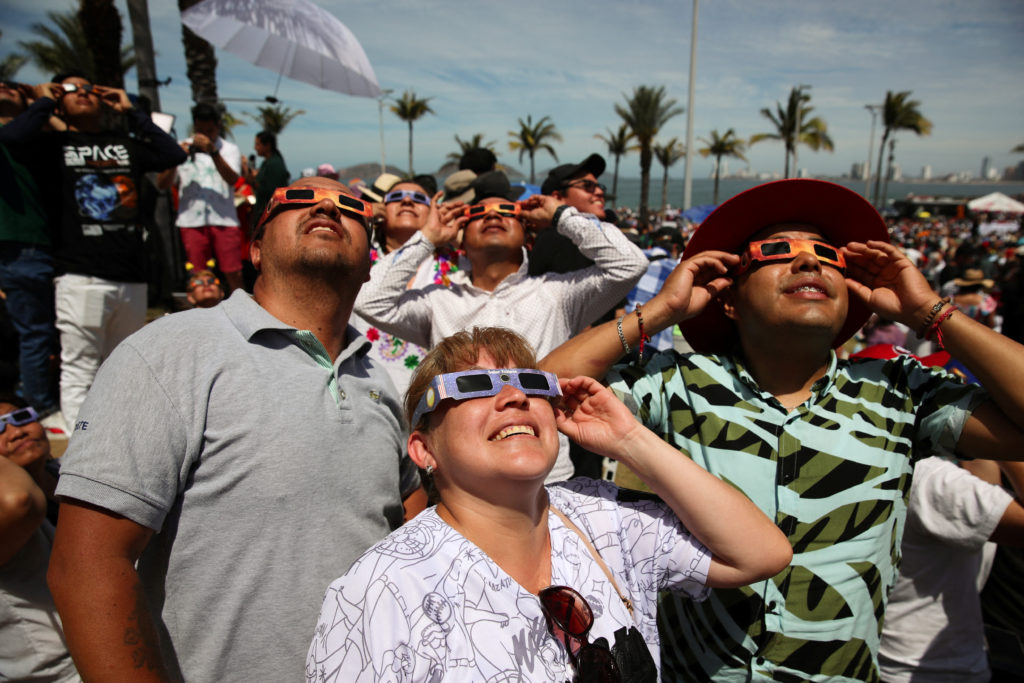 People use special protective glasses to observe a total solar eclipse in Mazatlan, Mexico April 8, 2024. Photo by Henry Romero/Reuters