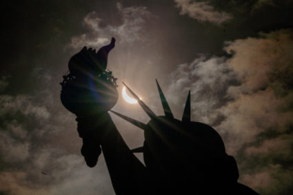 Statue of Liberty is seen during a partial solar eclipse