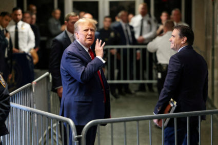 FILE PHOTO: Former U.S. President Donald Trump gestures outside the courtroom on the day of a court hearing on charges of falsifying business records to cover up a hush money payment to a porn star before the 2016 election, in New York State Supreme Court in the Manhattan borough of New York City, U.S., February 15, 2024. Photo by Andrew Kelly/Reuters