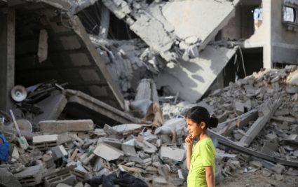 Palestinians inspect the site of an Israeli strike on a house in Rafah
