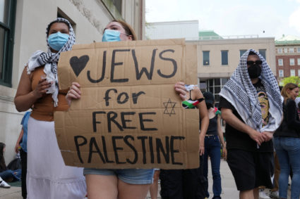 A protester holds a sign as students rally on Columbia University campus at a protest encampment in support of Palestinians, despite a 2 pm deadline issued by university officials to disband or face suspension, during the ongoing conflict between Israel and the Palestinian Islamist group Hamas, in New York City, U.S., April 29, 2024. Photo by David Dee Delgado/Reuters