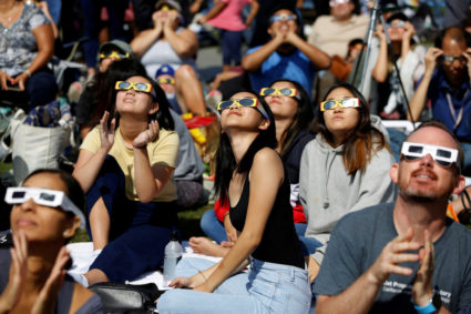 FILE PHOTO: People watch the solar eclipse on the lawn of Griffith Observatory in Los Angeles