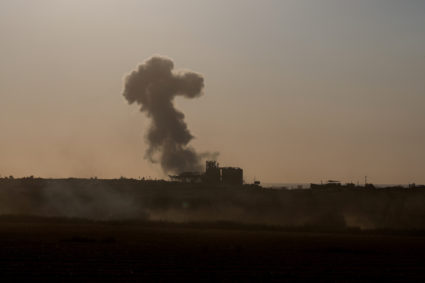 Smoke rises in Gaza, as an Israeli tank manoeuvres near the Israel-Gaza border