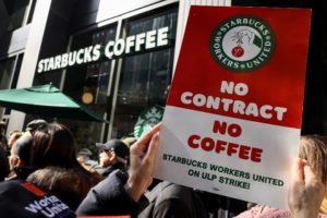 Members of the Starbucks Workers Union picket and hold a rally outside Starbucks store in New York