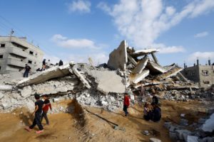 Palestinians inspect the site of an Israeli strike on a house, in Rafah