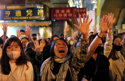 Protesters sing Glory to Hong Kong outside of Polytechnic University (PolyU) while police keep it under siege in Hong Kong, China, November 25, 2019. Picture taken November 25, 2019. Photo by Leah Millis/Reuters