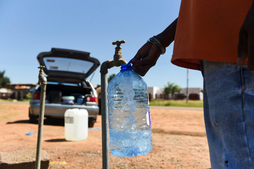A man fills a container of water from a tap outside the Klipdrift Water Treatment Plant in Hammanskraal in Pretoria, South...