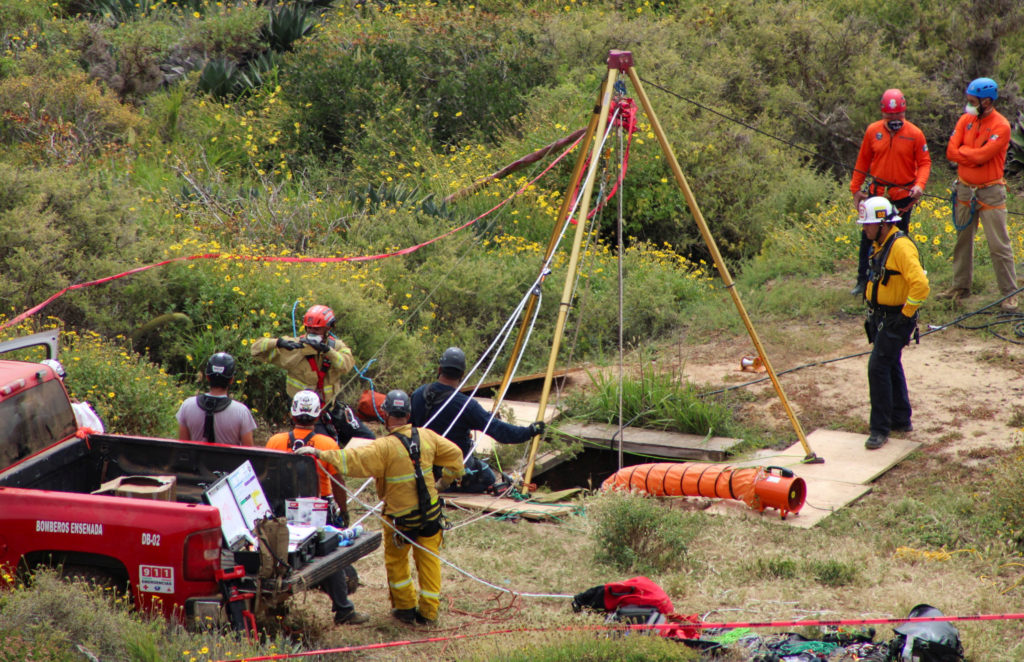 FILE PHOTO: Members of a rescue team work at a site where three bodies were found, in La Bocana