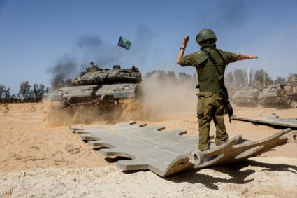 Israeli military vehicles are parked near the Israel-Gaza border