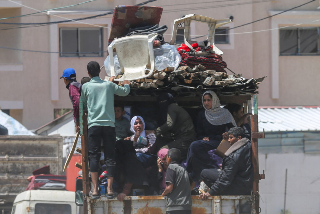 People flee the eastern parts of Rafah after the Israeli military began evacuating Palestinian civilians ahead of a threat...