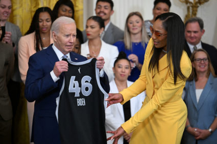 U.S. President Joe Biden is presented with a team jersey by Las Vegas Aces forward A'ja Wilson (22) as he welcomes the 2023 WNBA champion Las Vegas Aces during a celebration at the White House in Washington, U.S., May 9, 2024. Photo by Craig Hudson/Reuters