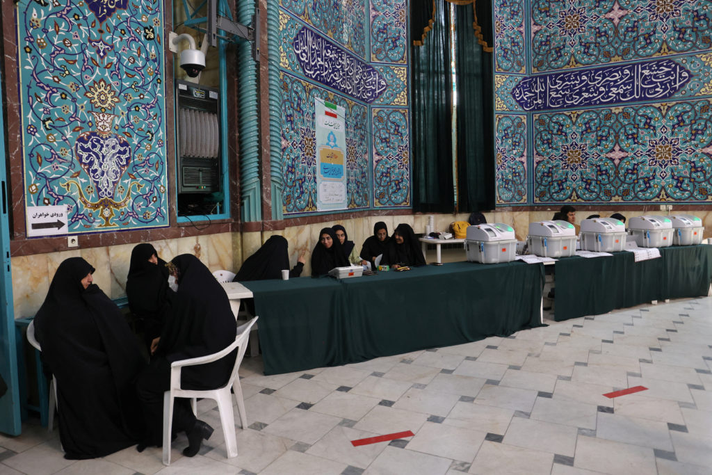 People vote during the runoff parliamentary elections in Tehran