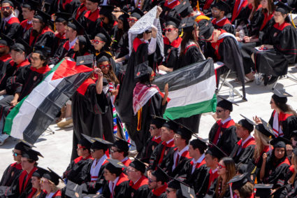 Graduates protesting the Israel-Hamas war hold Palestinian flags as they walk out during commencement at Camp Randall Stadium at the University of Wisconsin-Madison in Madison, Wisconsin, U.S. May 11, 2024. Photo by Mark Hoffman/Milwaukee Journal Sentinel/USA Today Network via REUTERS
