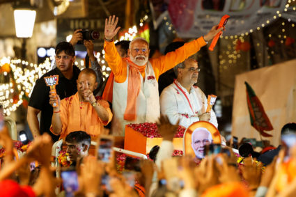 India's Prime Minister Narendra Modi and Chief Minister of Uttar Pradesh Yogi Adityanath show the Bharatiya Janata Party (BJP) symbol during a roadshow as part of an election campaign, in Varanasi, India, May 13, 2024. Photo by Adnan Abidi/Reuters
