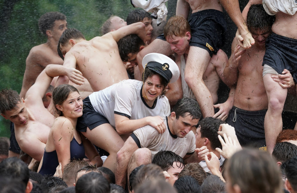 A member of the U.S. Naval Academy's first year class wears an upperclassman hat as she and fellow plebes climb the Herndon Monument, a granite obelisk coated with a thick layer of vegetable shortening, in a ritual marking the end of their plebe year in Annapolis, Maryland, U.S., May 15, 2024. Photo by Kevin Lamarque/Reuters