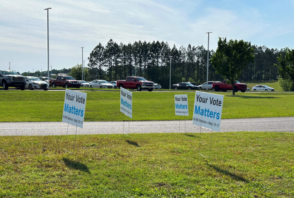 Signs urge the workers to vote line the road leading up to the Mercedes plant in Vance, Alabama, U.S., May 16, 2024. Photo by Nora Eckert/Reuters