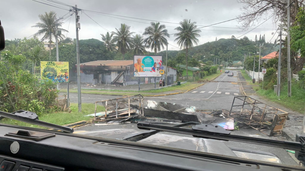 FILE PHOTO: A road is barricaded by rioters as they protest against plans to allow more people to take part in local elect...