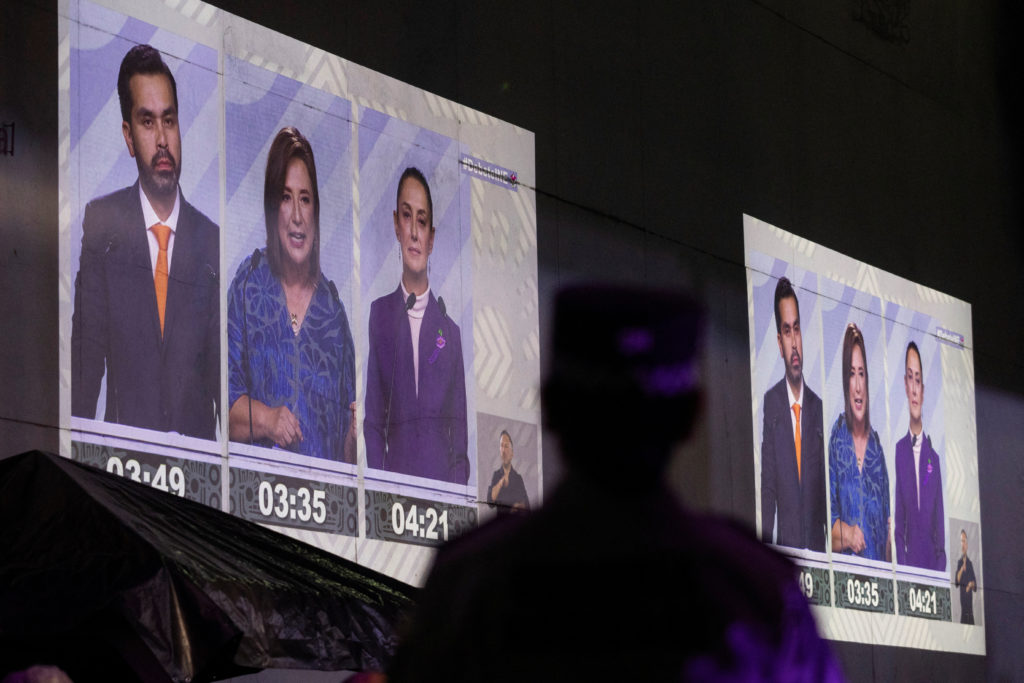 People watch the last presidential debate on a projection on a wall, at the Tlatelolco University Cultural Center, in Mexi...