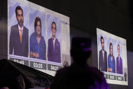 People watch the last presidential debate on a projection on a wall, at the Tlatelolco University Cultural Center, in Mexico City, Mexico, May 19, 2024. Photo by Quetzalli Nicte-Ha/Reuters