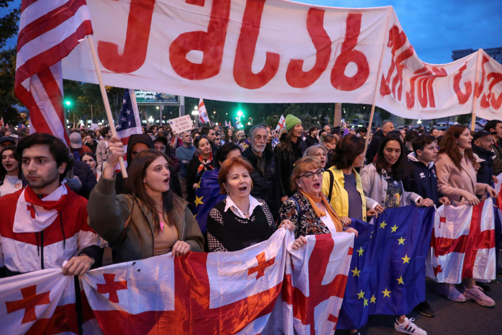 Demonstrators take part in a procession to protest against a bill on "foreign agents" and to support Georgia's membership ...