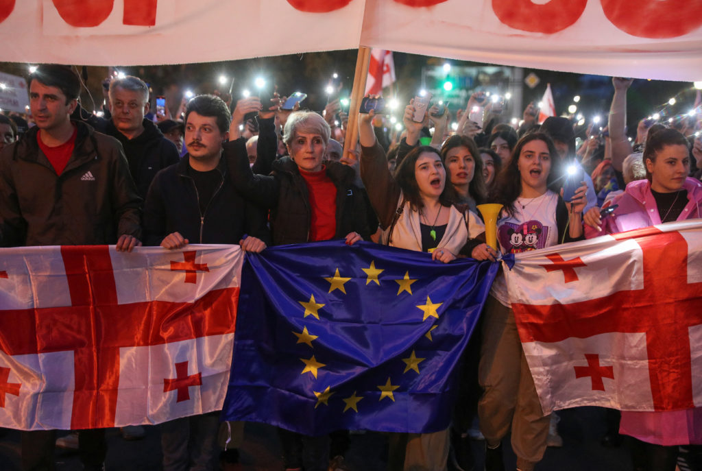 Demonstrators take part in a procession to protest against a bill on "foreign agents" and to support Georgia's membership ...