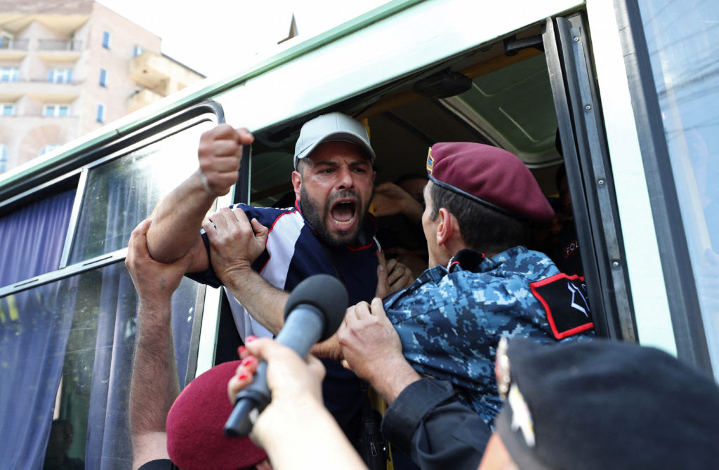 A demonstrator shouts from a police bus during an anti-government protest demanding the resignation of Armenian Prime Mini...
