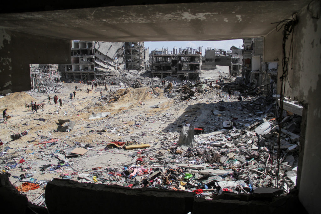 Palestinians inspect the damages after Israeli forces withdrew from a part of Jabalia refugee camp, in the northern Gaza S...