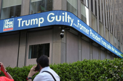 People look at Fox News screens displaying news announcing that a jury found former U.S. President Donald Trump guilty on ...