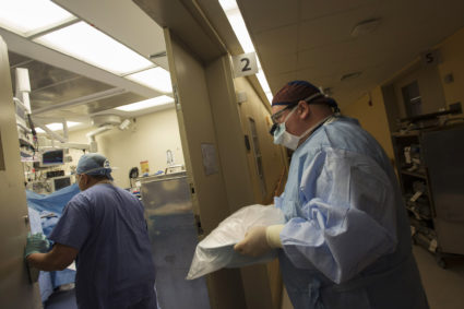 Surgeon Guarrera carries donated harvested kidney to transplant into patient Abernathy as part of five-way organ transplan...