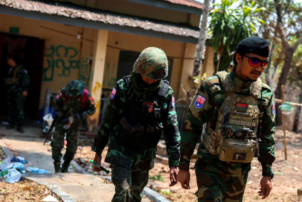 LT Saw Kaw, a soldier of the Karen National Liberation Army (KNLA) , walks with his team members after inspecting the hous...