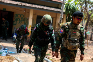 LT Saw Kaw, a soldier of the Karen National Liberation Army (KNLA) , walks with his team members after inspecting the hous...