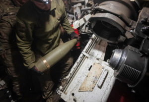 Ukrainian servicemen prepare a M109 self-propelled howitzer to fire towards Russian troops near the town of Vovchansk