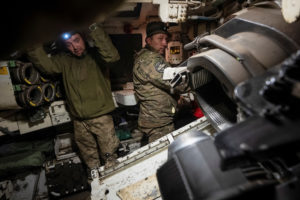 Ukrainian servicemen prepare a M109 self-propelled howitzer to fire towards Russian troops near the town of Vovchansk