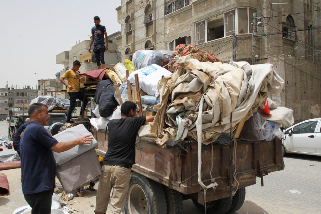 Palestinians prepare to evacuate, after Israeli forces launched a ground and air operation in the eastern part of Rafah
