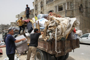 Palestinians prepare to evacuate, after Israeli forces launched a ground and air operation in the eastern part of Rafah