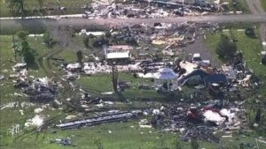 Wreckage is strewn across a property the day after a deadly series of tornados in Texas