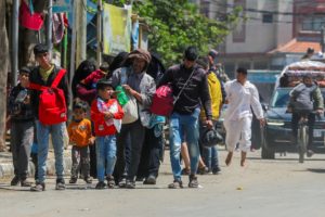 People flee the eastern parts of Rafah after the Israeli military began evacuating Palestinian civilians ahead of a threat...