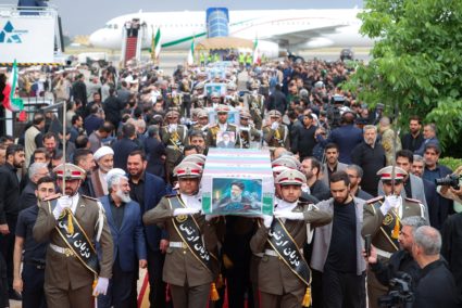 Soldiers carry the coffin of the late Iranian President Ebrahim Raisi at Mehrabad Airport in Tehran