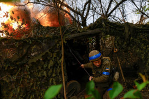Ukrainian National Guard 'Khartiia' brigade service member and a D-20 howitzer crew commander Ivan Liashko fires towards R...