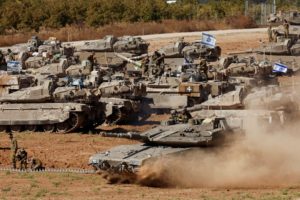 An Israeli tank maneuvers, amid the ongoing conflict between Israel and the Palestinian Islamist group Hamas, near the Isr...