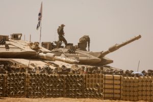 Israeli soldiers operate a military vehicle, near the Israel-Gaza Border, in southern Israel