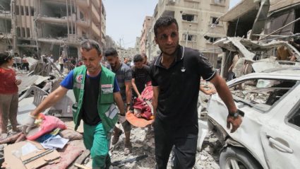 Palestinians carry the body of a person killed in an Israeli strike on a house, in Beit Lahia