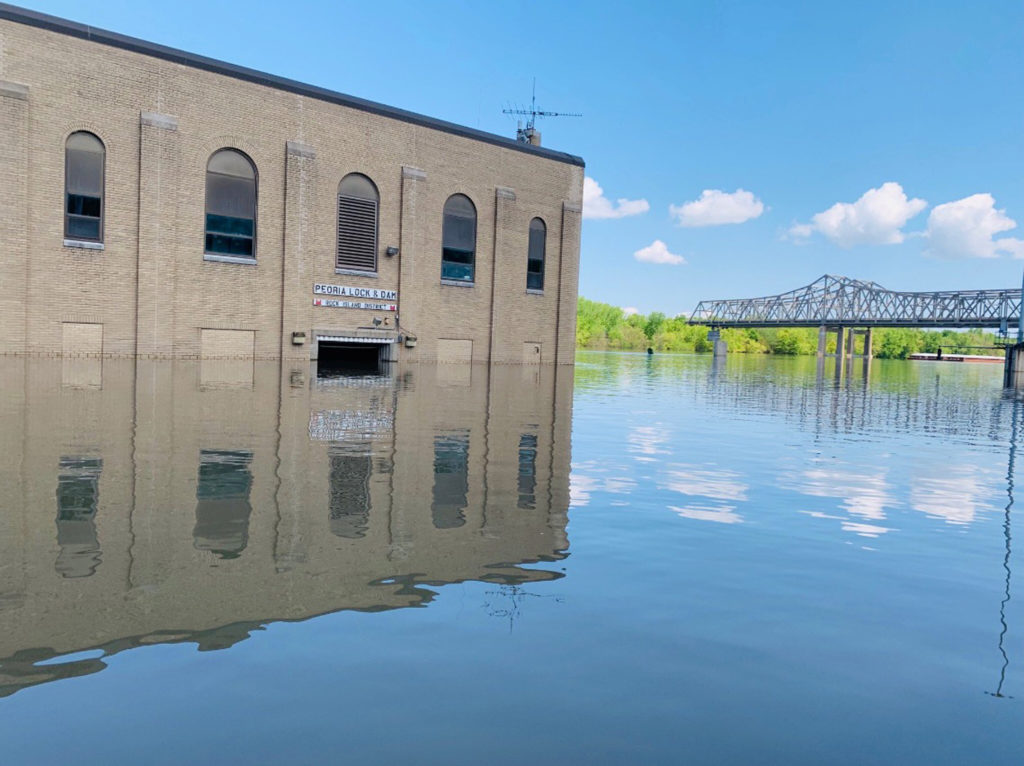 Handout photo of the Peoria Lock and Dam building is shown surrounded by flood waters of the Mississippi River in Peoria, ...